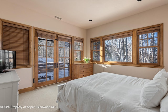 carpeted bedroom featuring french doors