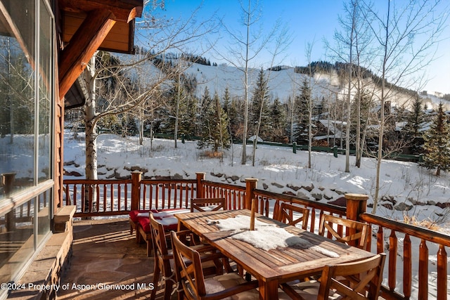 snow covered deck featuring a mountain view