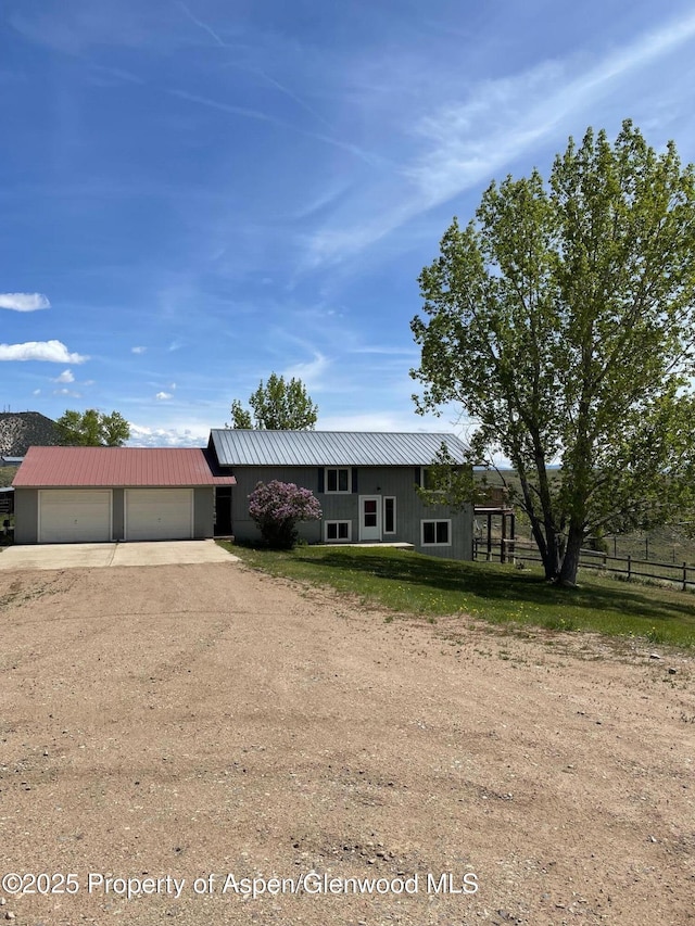 620 Ponderosa Pass, Craig, CO 81625 - view of front of home with dirt driveway, a metal roof, and a garage