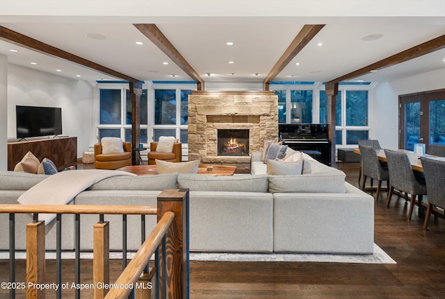 living room featuring dark hardwood / wood-style flooring, a fireplace, and beam ceiling