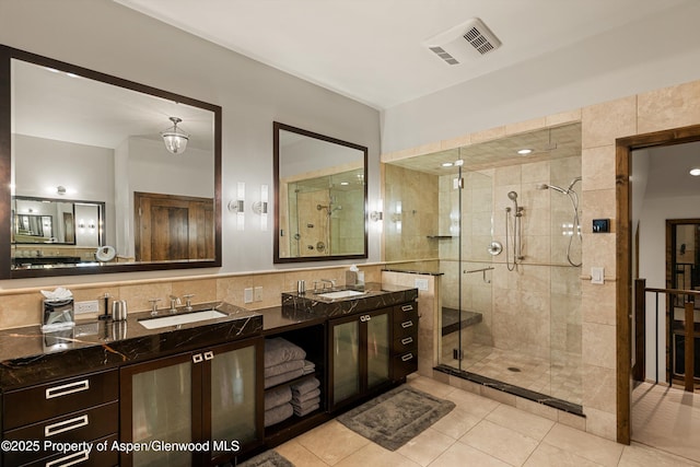 bathroom with vanity, tile patterned floors, tile walls, and walk in shower