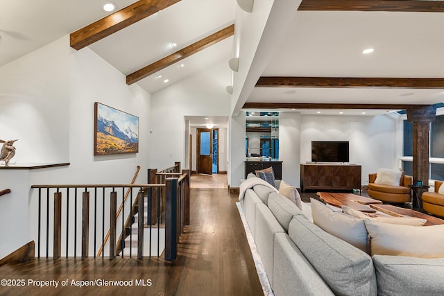 living room with beam ceiling, dark hardwood / wood-style flooring, and high vaulted ceiling