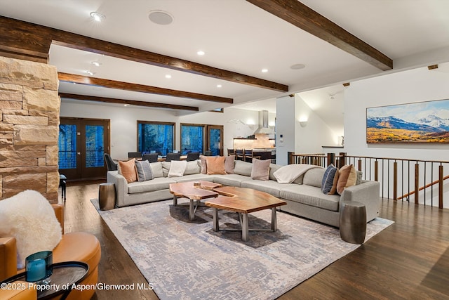 living room with beam ceiling, dark hardwood / wood-style floors, and french doors