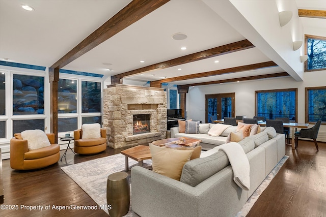 living room featuring a fireplace, dark hardwood / wood-style flooring, and beam ceiling