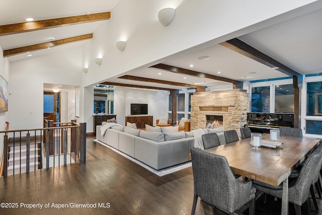 interior space featuring beamed ceiling, a fireplace, dark hardwood / wood-style flooring, and high vaulted ceiling