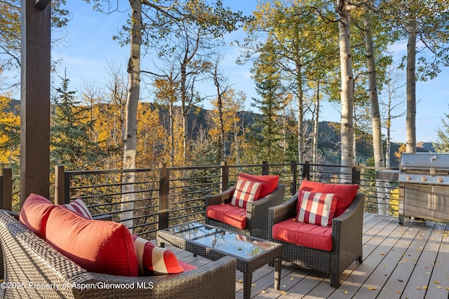 wooden deck with grilling area and a mountain view