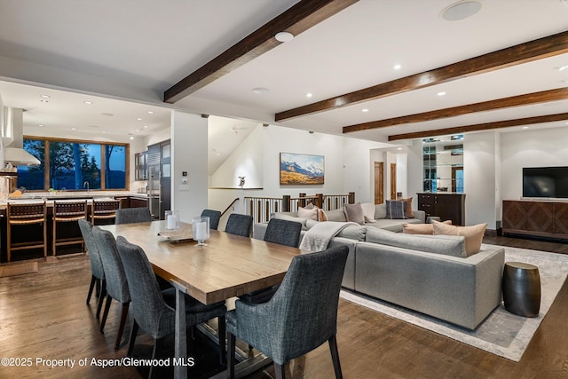 dining area featuring hardwood / wood-style floors and beam ceiling