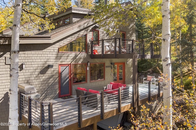 back of property featuring outdoor lounge area and a balcony