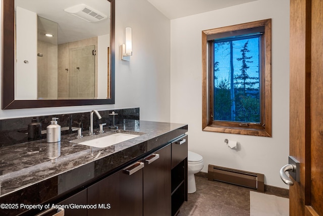 bathroom featuring a shower, vanity, baseboard heating, and toilet