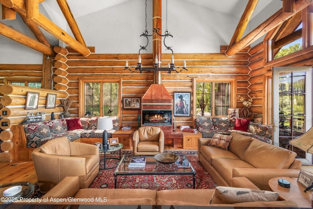 408 Gerbaz Way, Snowmass, CO 81654 - living area featuring rustic walls, high vaulted ceiling, wood finished floors, and a chandelier