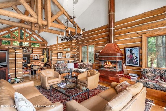 408 Gerbaz Way, Snowmass, CO 81654 - living room with log walls, high vaulted ceiling, and wood finished floors