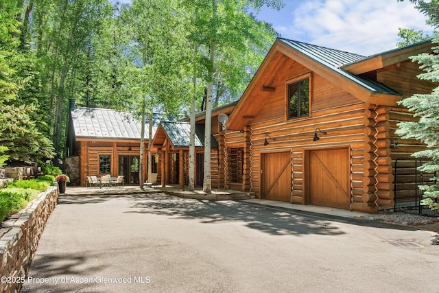 408 Gerbaz Way, Snowmass, CO 81654 - log-style house with a standing seam roof, log siding, asphalt driveway, and a metal roof