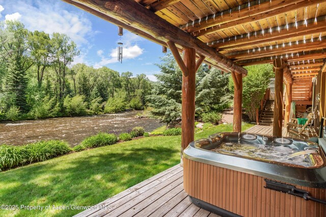 408 Gerbaz Way, Snowmass, CO 81654 - wooden terrace featuring a hot tub, stairway, and a lawn