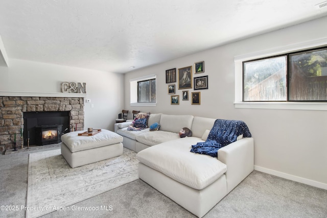 10 Spruce Ct, Parachute, CO 81635 - carpeted living area featuring baseboards and a stone fireplace