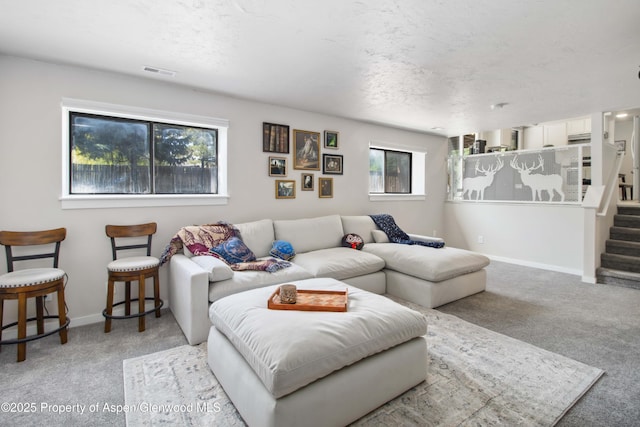 10 Spruce Ct, Parachute, CO 81635 - carpeted living room with stairway and a textured ceiling