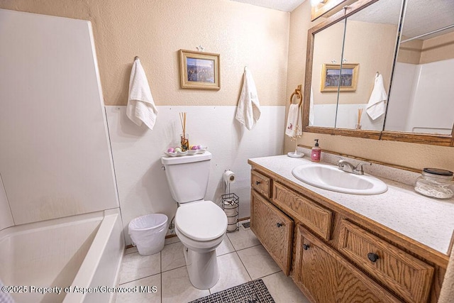 bathroom featuring tile patterned flooring, vanity, and toilet