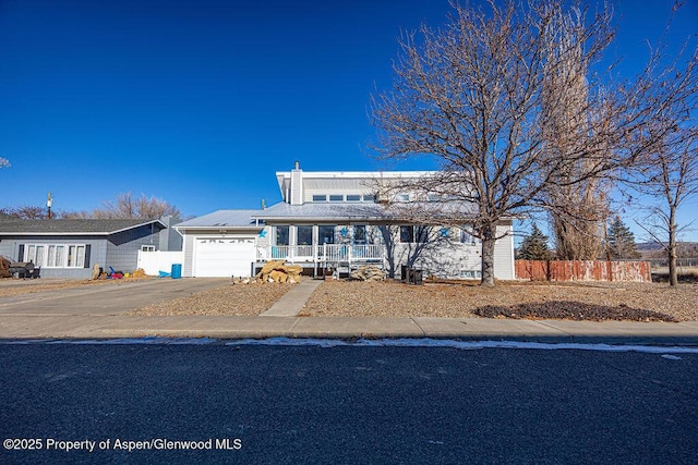 view of front of home with a porch and a garage