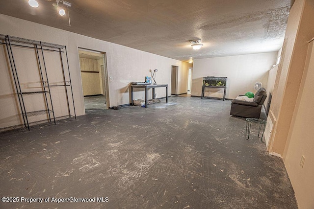 basement featuring a textured ceiling