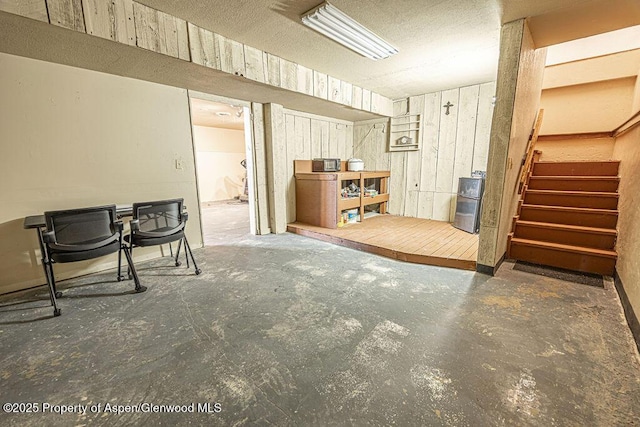 basement featuring wooden walls