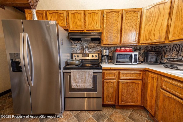 kitchen with backsplash and stainless steel appliances