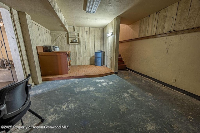 basement featuring a textured ceiling