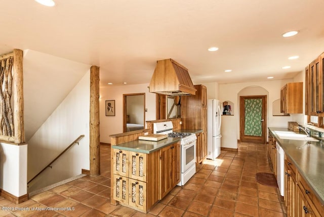 222 Crest Point Dr, Carbondale, CO 81623 - kitchen with premium range hood, white appliances, and sink