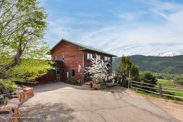 view of side of property with a mountain view