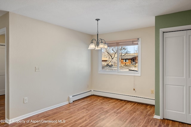 unfurnished dining area with wood-type flooring and a chandelier