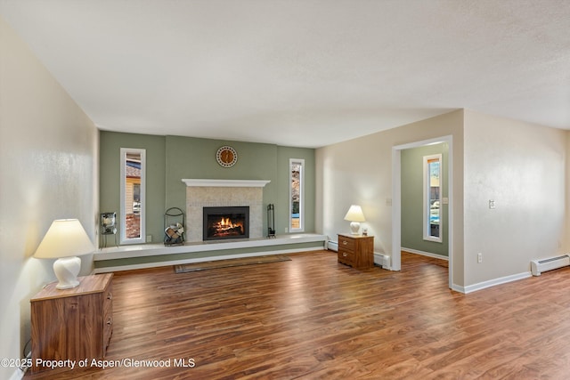 living room featuring hardwood / wood-style flooring and a baseboard heating unit