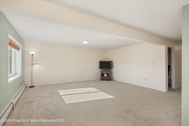 unfurnished living room featuring a baseboard radiator and light colored carpet