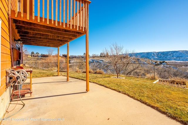 view of patio / terrace with a deck with mountain view