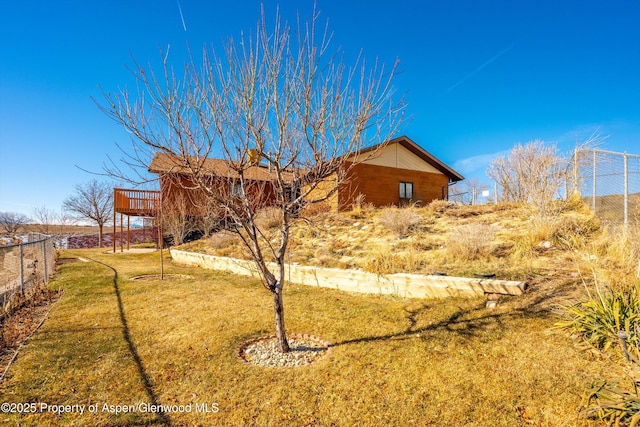 exterior space with a lawn and a wooden deck