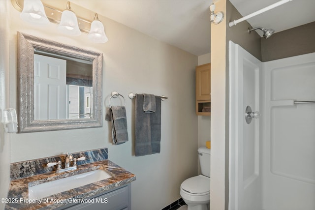 bathroom with a shower, vanity, and toilet