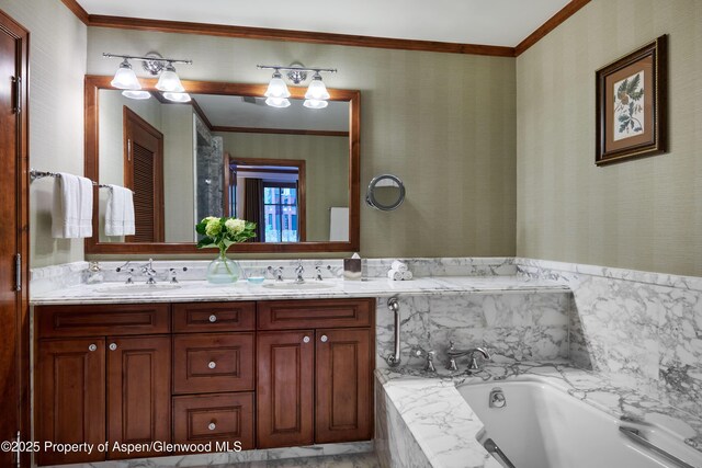 bathroom featuring tiled bath, crown molding, and vanity