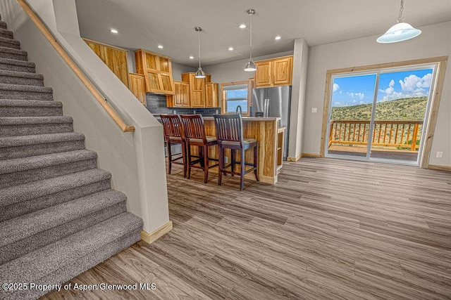118 Highland Dr, Craig, CO 81625 - kitchen featuring open floor plan, a breakfast bar, recessed lighting, light wood finished floors, and hanging light fixtures