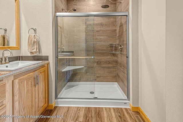 118 Highland Dr, Craig, CO 81625 - full bath featuring vanity, a stall shower, and wood finished floors