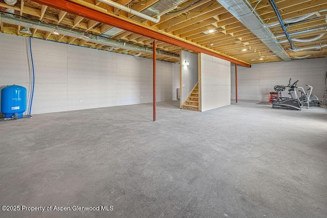 118 Highland Dr, Craig, CO 81625 - unfinished below grade area featuring a water pressure tank and stairway