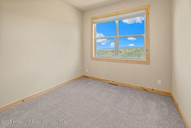 118 Highland Dr, Craig, CO 81625 - carpeted empty room featuring baseboards
