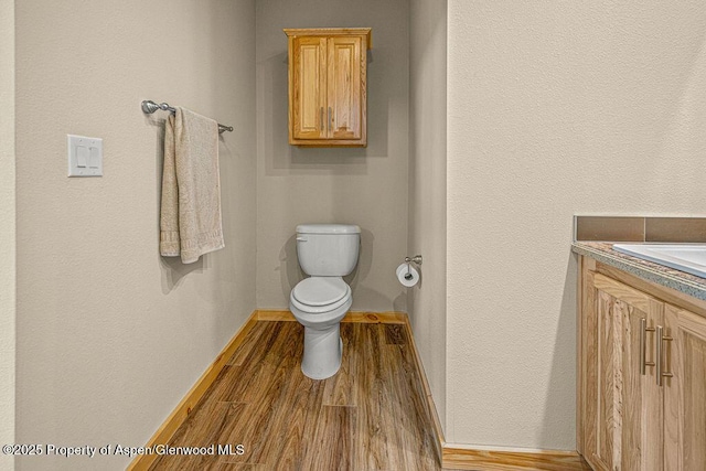 118 Highland Dr, Craig, CO 81625 - half bathroom featuring vanity and wood finished floors