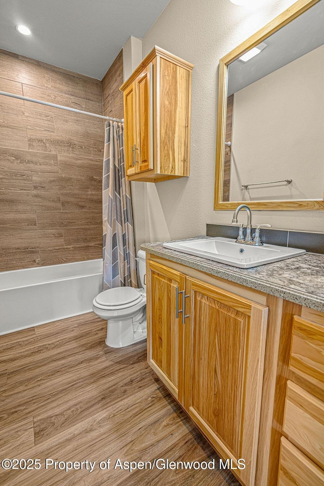 118 Highland Dr, Craig, CO 81625 - full bath with vanity, shower / bath combo, and wood finished floors