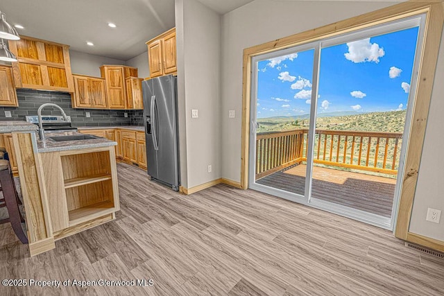 118 Highland Dr, Craig, CO 81625 - kitchen featuring stainless steel fridge with ice dispenser, open shelves, backsplash, light wood-style flooring, and recessed lighting