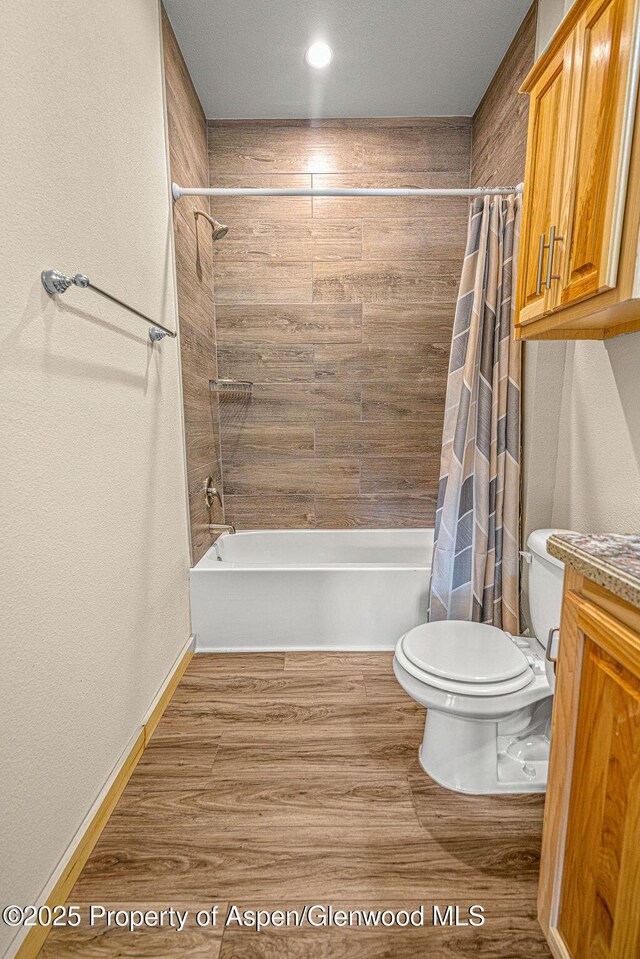 118 Highland Dr, Craig, CO 81625 - bathroom featuring shower / bathtub combination with curtain, vanity, and wood finished floors