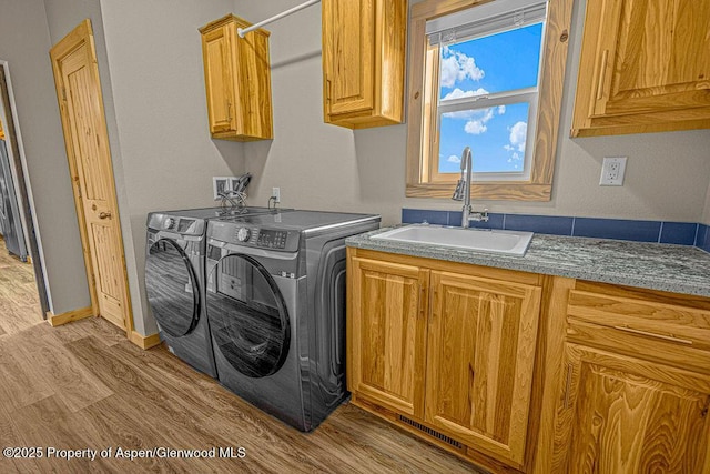 118 Highland Dr, Craig, CO 81625 - washroom with cabinet space, washer and clothes dryer, and wood finished floors