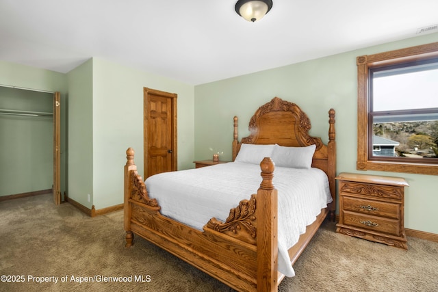 bedroom with a closet, carpet, visible vents, and baseboards