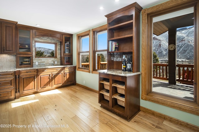 bar with baseboards, tasteful backsplash, recessed lighting, and light wood-style floors