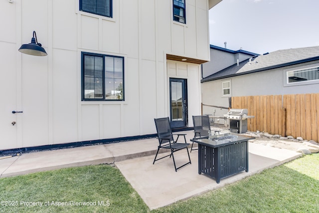 view of patio / terrace with an outdoor fire pit, fence, and grilling area