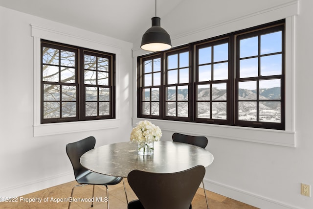 2908 Juniper Hill Dr, Aspen, CO 81611 - dining space with light tile patterned flooring, lofted ceiling, and a mountain view