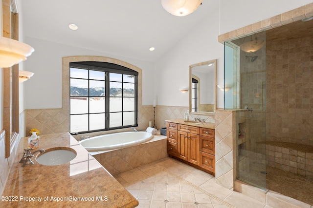 2908 Juniper Hill Dr, Aspen, CO 81611 - full bath featuring tile patterned floors, two vanities, a shower stall, a garden tub, and vaulted ceiling