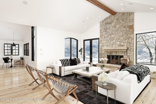 2908 Juniper Hill Dr, Aspen, CO 81611 - living room with light wood-type flooring, beam ceiling, a stone fireplace, recessed lighting, and high vaulted ceiling