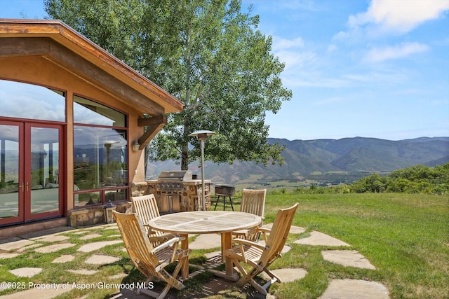 2908 Juniper Hill Dr, Aspen, CO 81611 - view of green lawn featuring a mountain view, french doors, and outdoor dining space